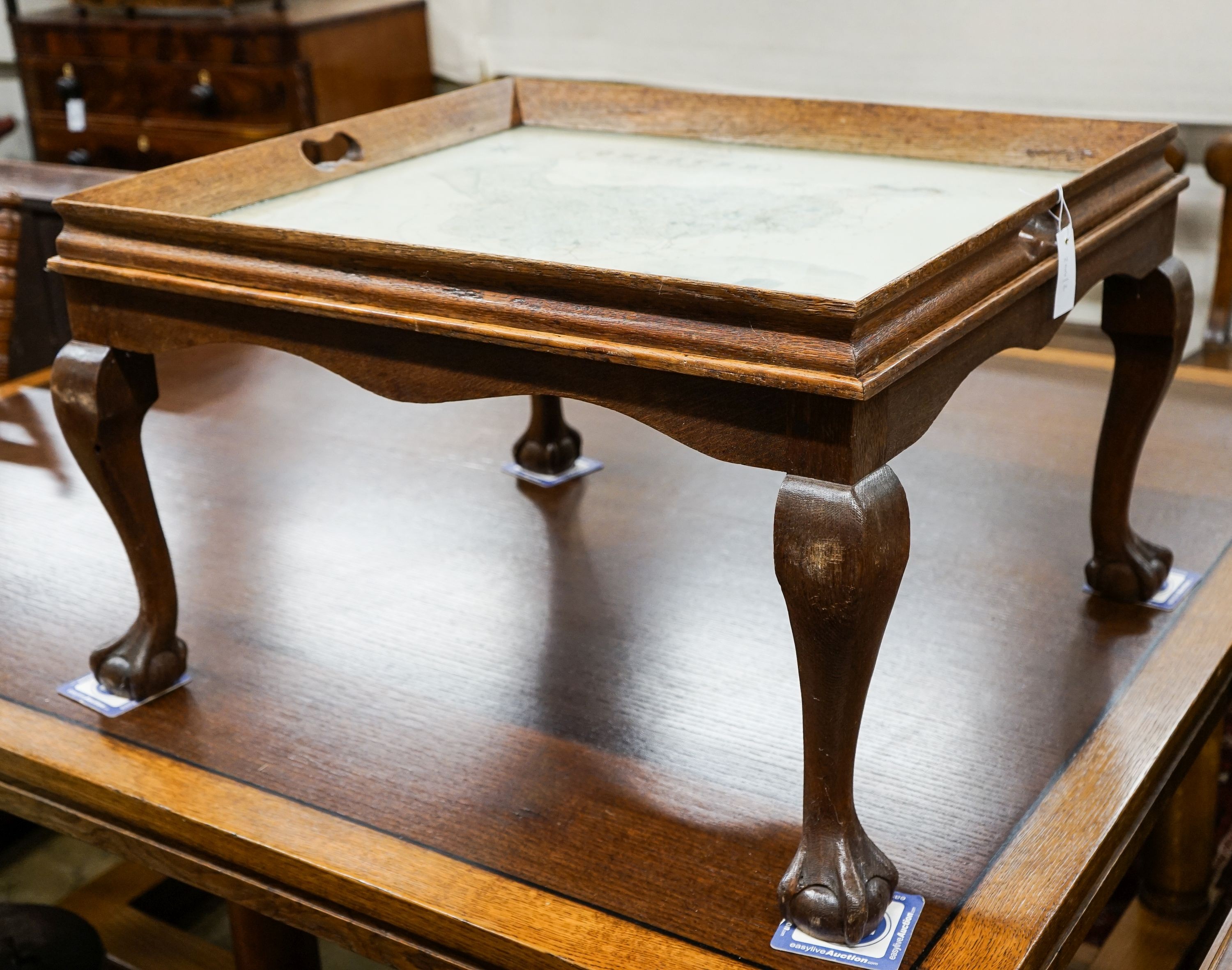 A rectangular oak tray top low table inset with a map of Cheshire on ball and claw stand, width 80cm, depth 70cm, height 48cm